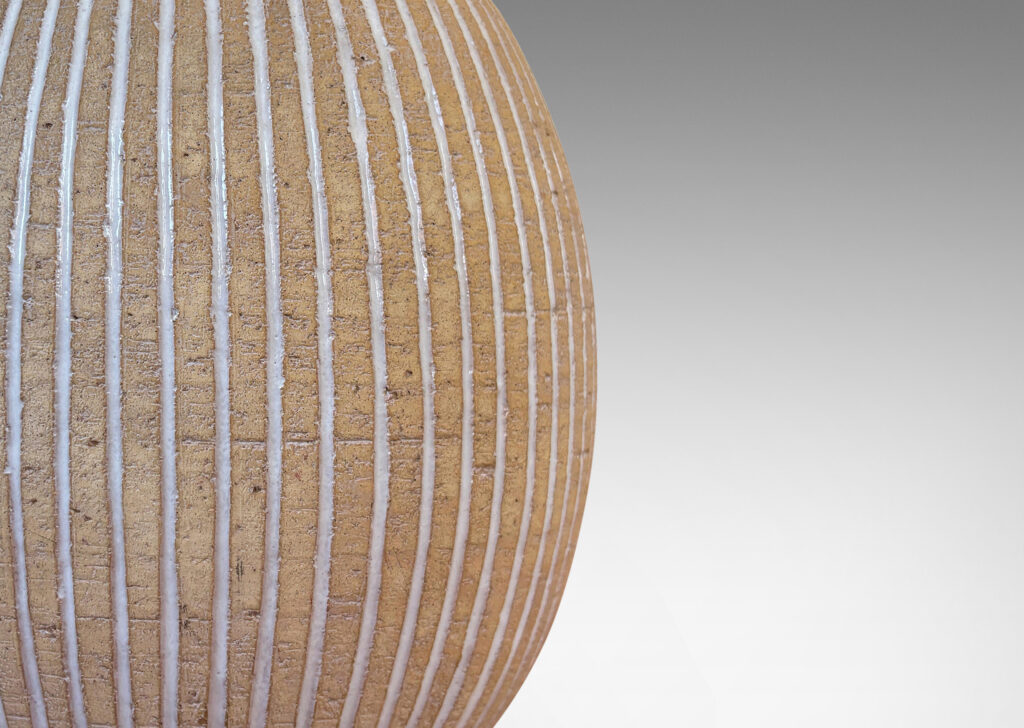 Gallery BAC light tan ovoid form with carved and white-glazed vertical pinstripes