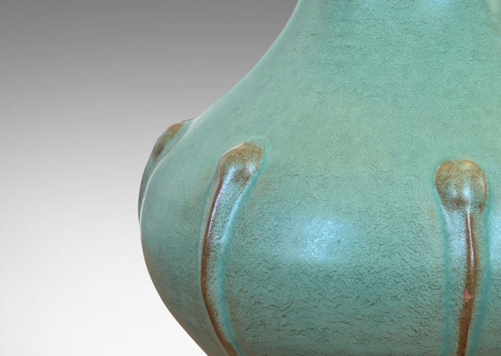 Gallery BAC bulbous form with outstretched mouth and relief organic motifs, in a celadon green glaze with brown accents