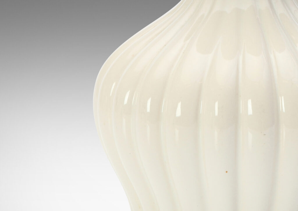 Gallery BAC reeded swelling form with sprouting mouth in a gloss white glaze