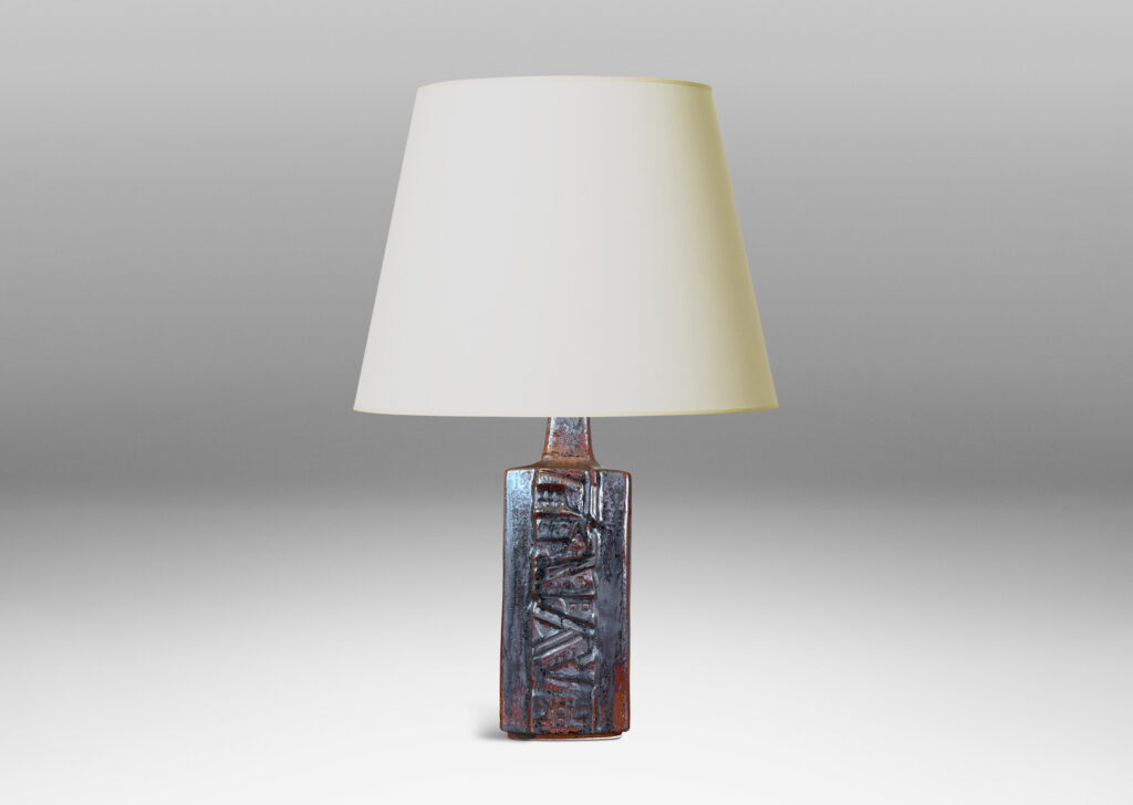 Gallery BAC rectangular bottle form with wide bands of geometric ornament in relief, glazed in an oxblood with gray glaze