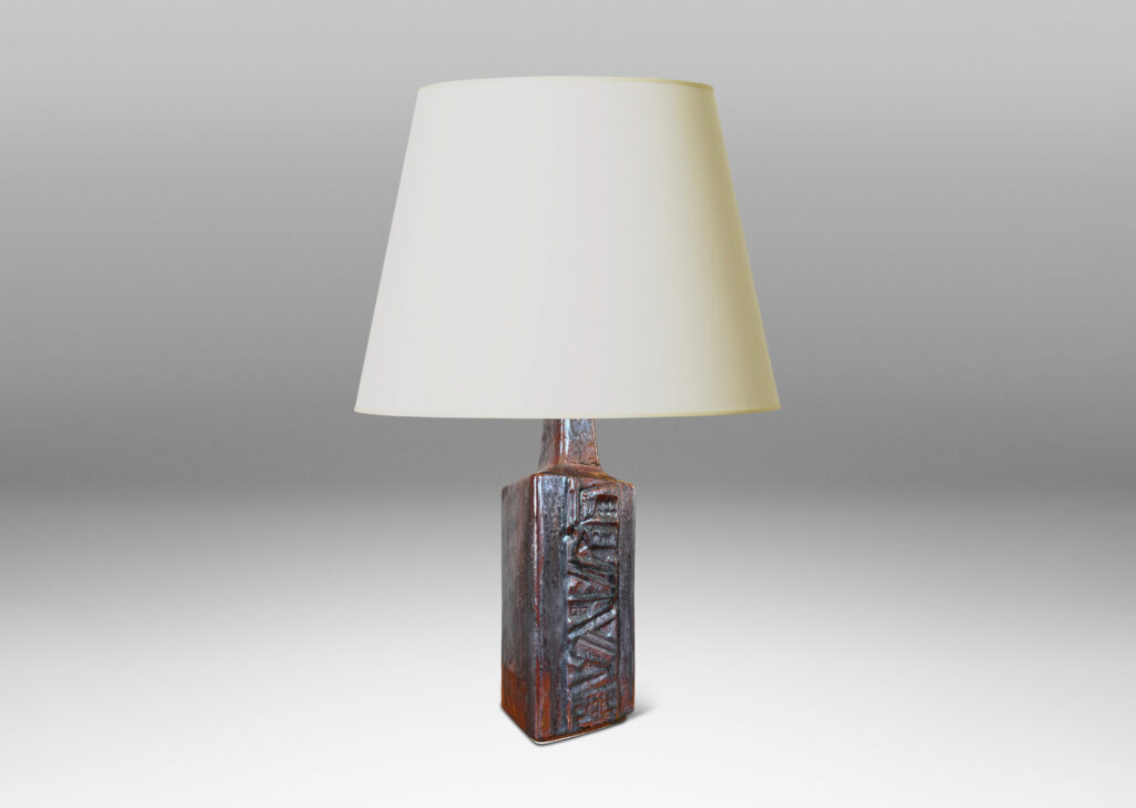 Gallery BAC rectangular bottle form with wide bands of geometric ornament in relief, glazed in an oxblood with gray glaze