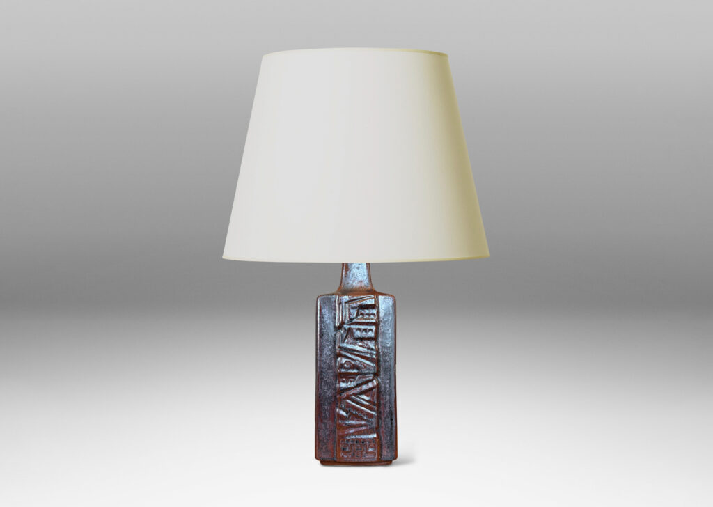 Gallery BAC rectangular bottle form with wide bands of geometric ornament in relief, glazed in an oxblood with gray glaze