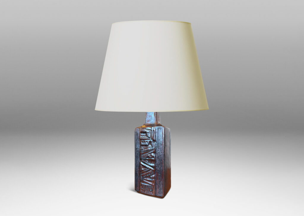 Gallery BAC rectangular bottle form with wide bands of geometric ornament in relief, glazed in an oxblood with gray glaze