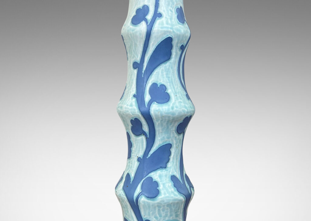 Gallery BAC tiered stand and round base, with carved floral pattern in French blue against pale cerulean
