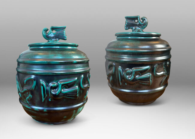 Gallery BAC wide relief band of abstract bird and foliate motifs, with lid topped with a bird finial, in deep tonal teal copper oxide glazing