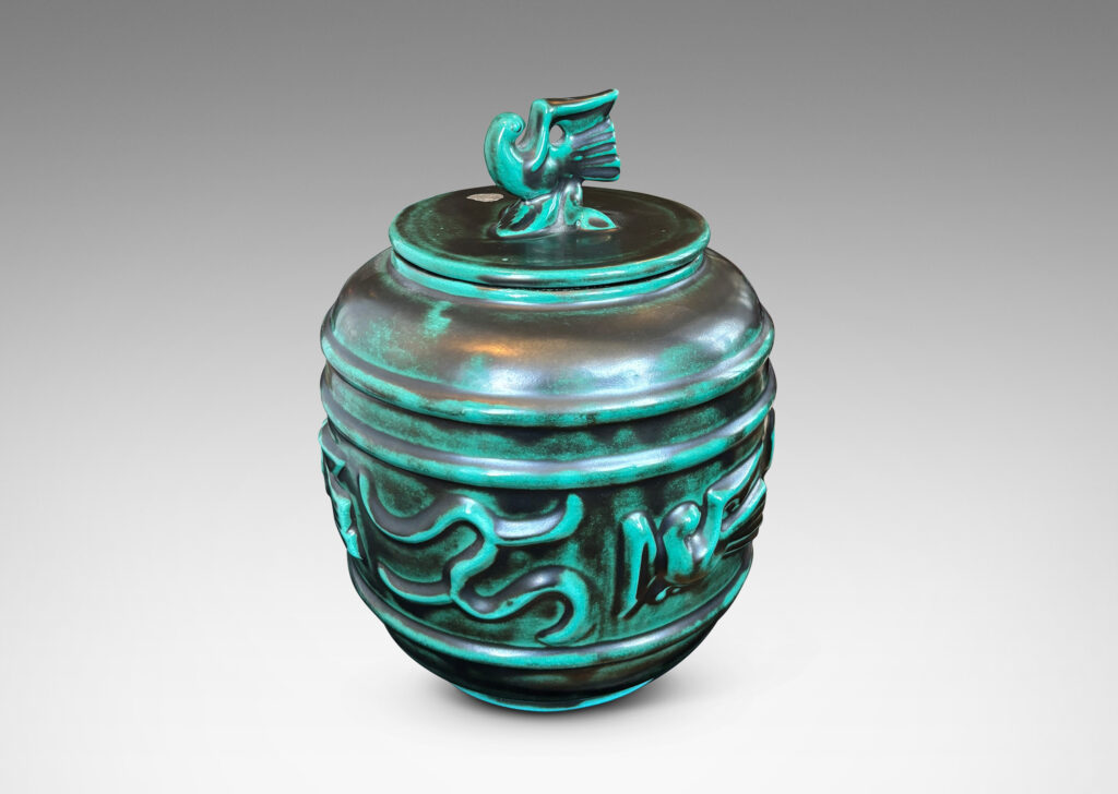 Gallery BAC wide relief band of abstract bird and foliate motifs, with lid topped with a bird finial, in deep tonal teal copper oxide glazing