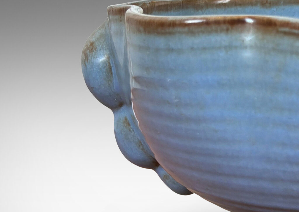Gallery BAC lobed lip, ridged surfaces, and bubble handles, glazed in a cornflower blue with brown accents