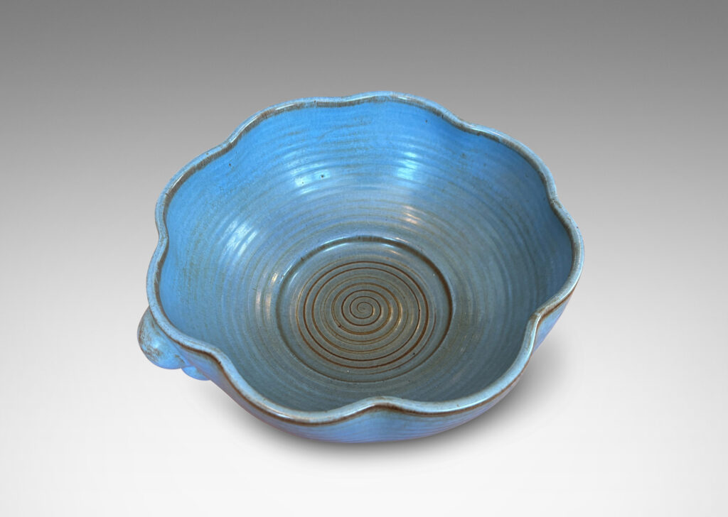 Gallery BAC lobed lip, ridged surfaces, and bubble handles, glazed in a cornflower blue with brown accents