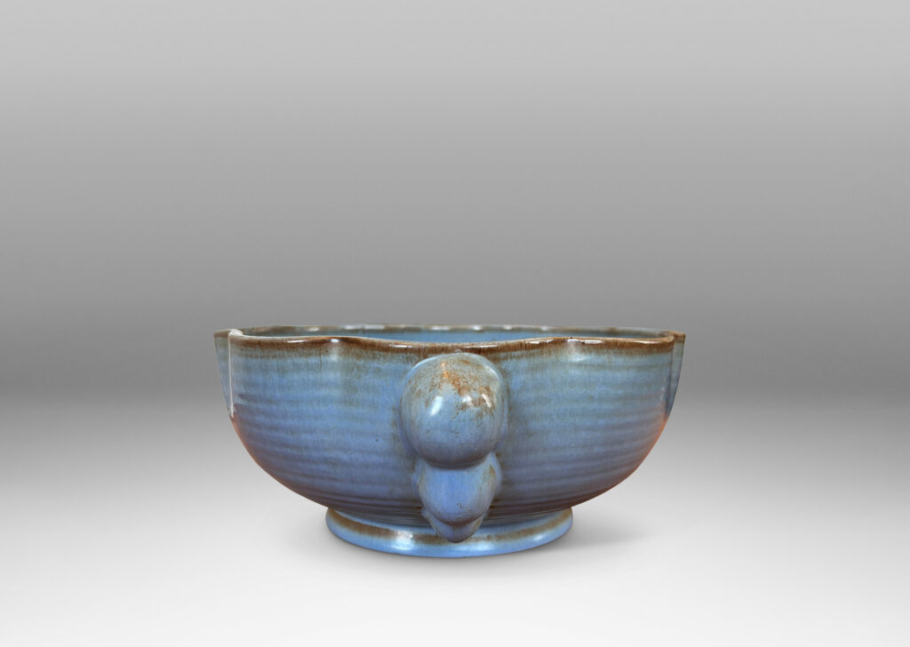 Gallery BAC lobed lip, ridged surfaces, and bubble handles, glazed in a cornflower blue with brown accents