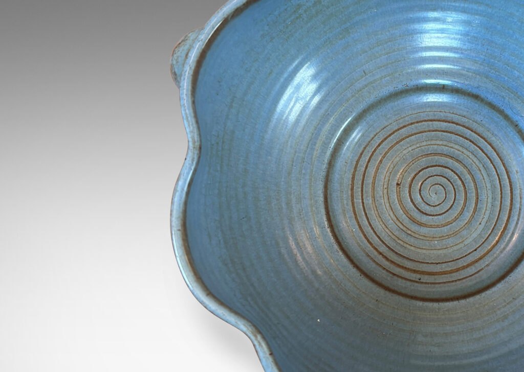 Gallery BAC lobed lip, ridged surfaces, and bubble handles, glazed in a cornflower blue with brown accents