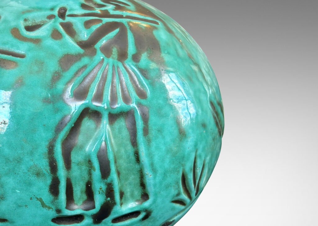 Gallery BAC plump globe form with carved countryside figures of animals, farmers and trees, in a tonal teal copper oxide glaze