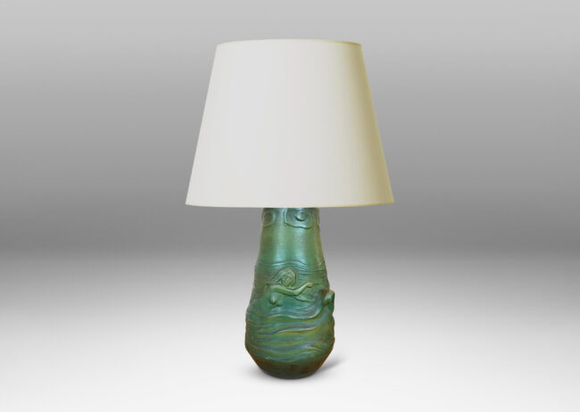 Gallery BAC bell-like form encircled in reliefs depicting waves, fish, mermaids and cloud ball motifs, glazed in a matte dark green