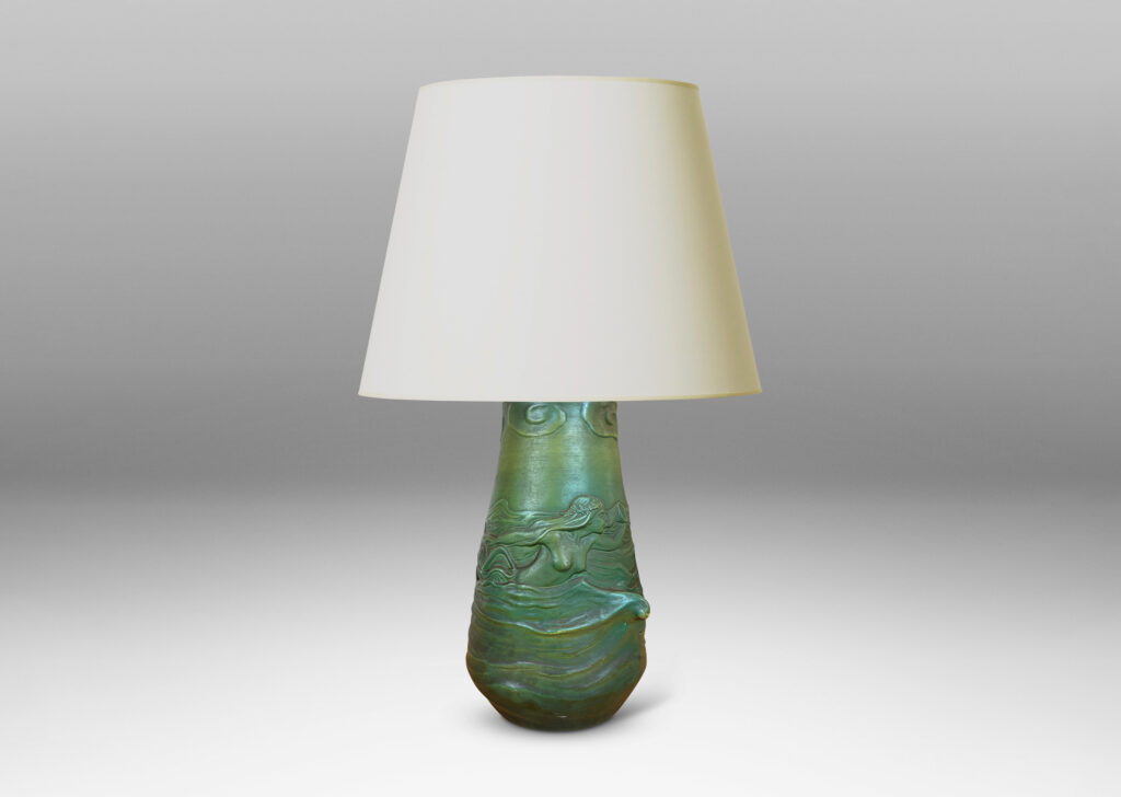 Gallery BAC bell-like form encircled in reliefs depicting waves, fish, mermaids and cloud ball motifs, glazed in a matte dark green