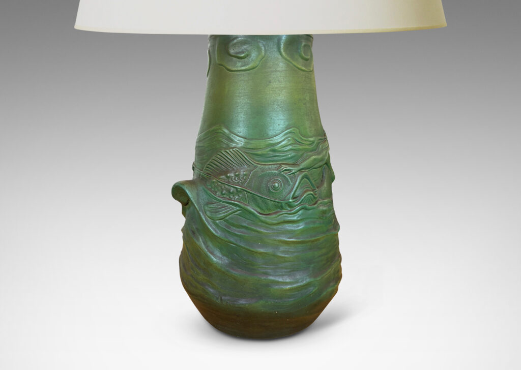 Gallery BAC bell-like form encircled in reliefs depicting waves, fish, mermaids and cloud ball motifs, glazed in a matte dark green