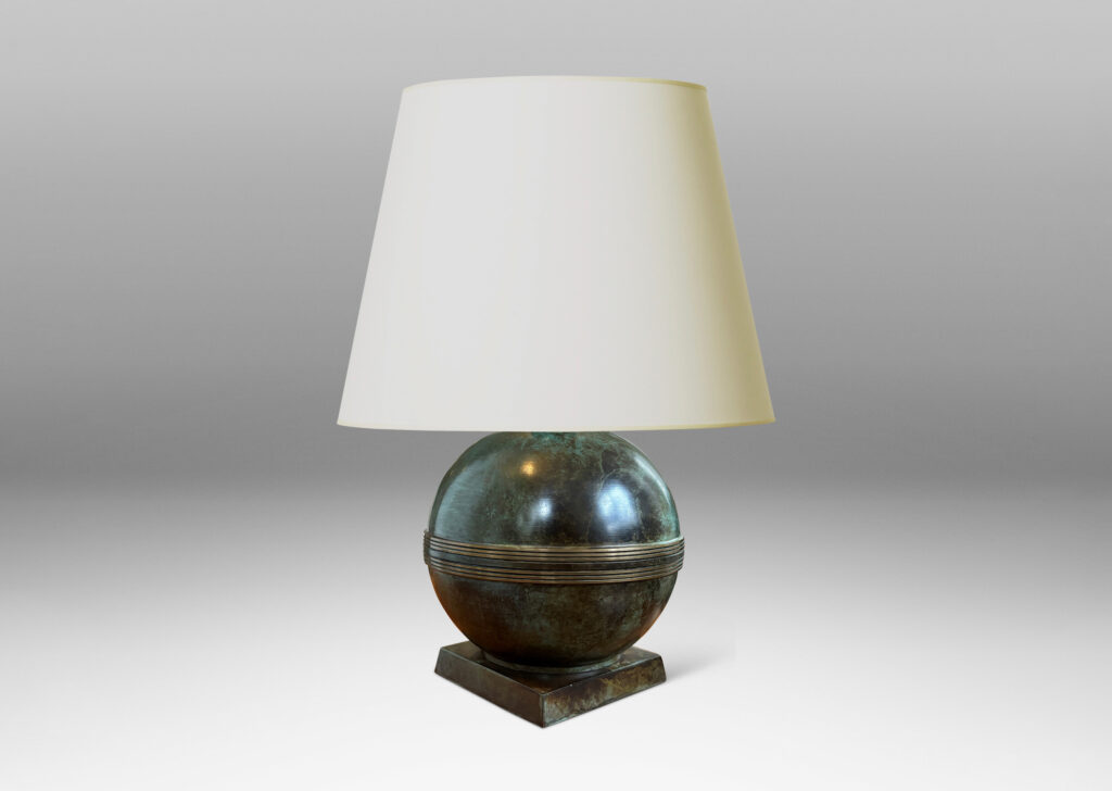 Gallery BAC globe forms with engraved bands, mounted on an angled square plinth, having a handsome original patination; bronze