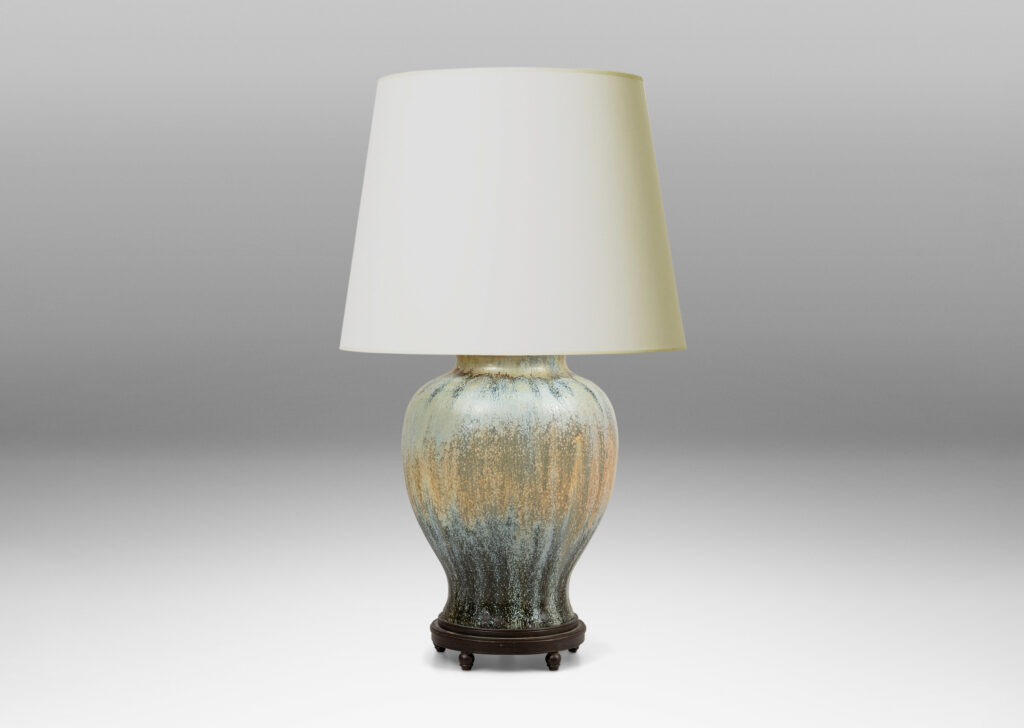 Gallery BAC swelling form glazed in a spectacular flowing ice blue, olive and blue-black, with very fine patinated base with ball feet and top with floating filigree rosette