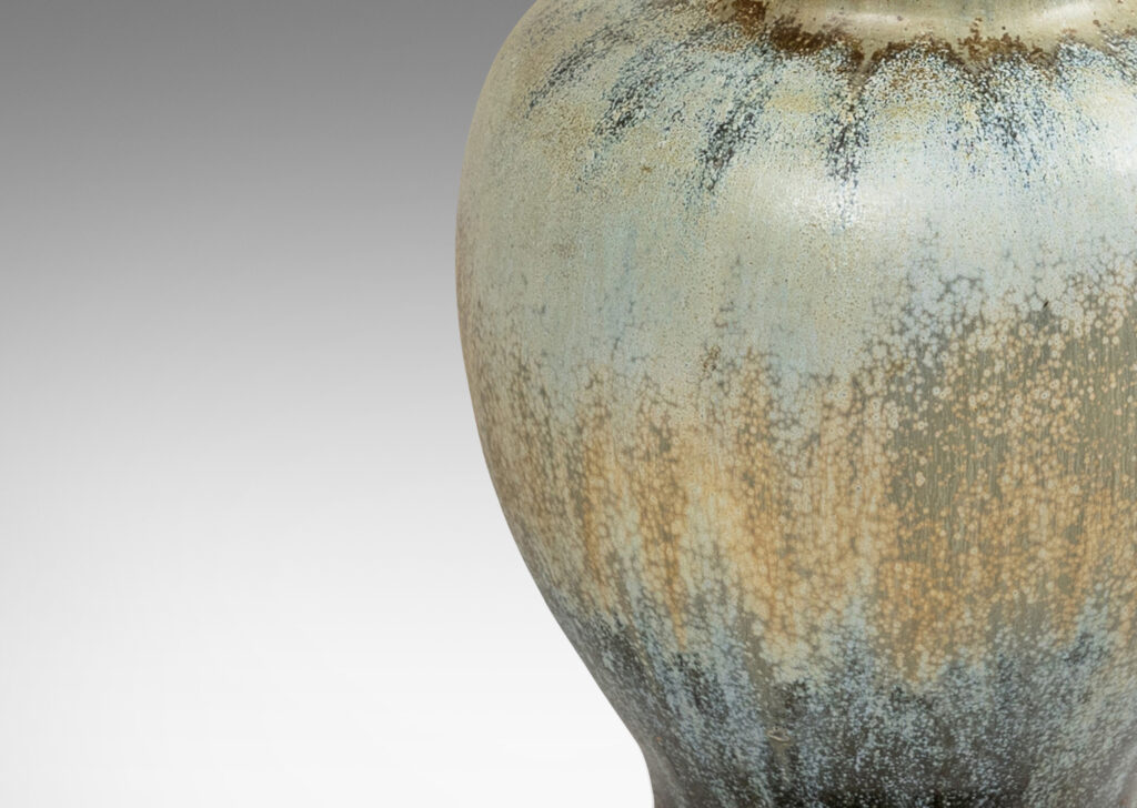 Gallery BAC swelling form glazed in a spectacular flowing ice blue, olive and blue-black, with very fine patinated base with ball feet and top with floating filigree rosette