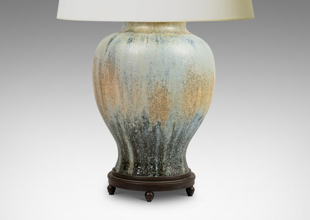 Gallery BAC swelling form glazed in a spectacular flowing ice blue, olive and blue-black, with very fine patinated base with ball feet and top with floating filigree rosette