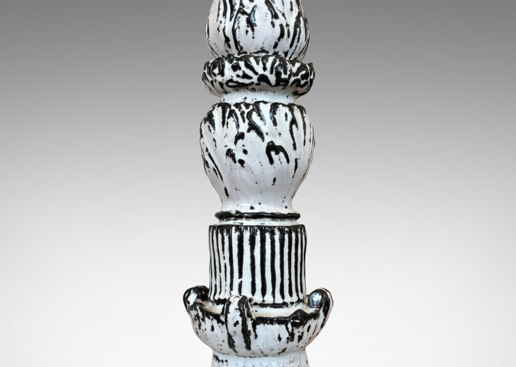 Gallery BAC tiered forms carved with balls of acanthus leave, bands of strikes and scrolling forms, wonderfully accentuated in a white-black tin glaze