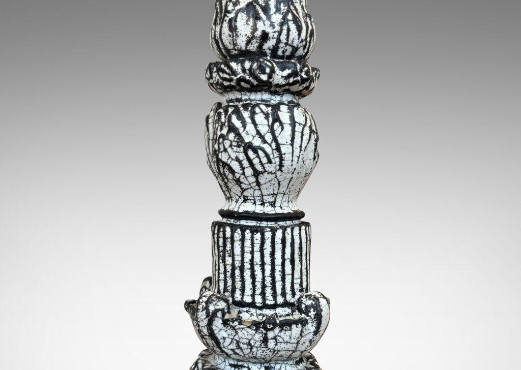 Gallery BAC tiered forms carved with balls of acanthus leave, bands of strikes and scrolling forms, wonderfully accentuated in a white-black tin glaze