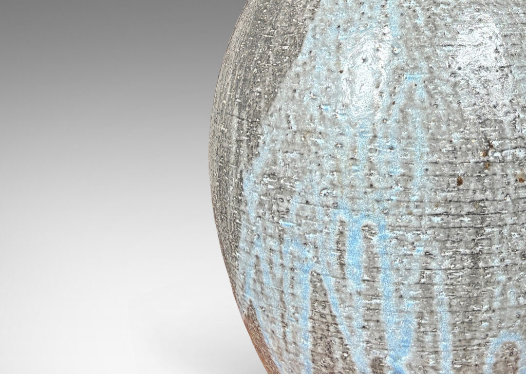 Gallery BAC ovoid form and tall slender neck carved with ridges and glazed in flowing light blue over gray