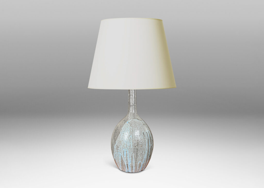 Gallery BAC ovoid form and tall slender neck carved with ridges and glazed in flowing light blue over gray