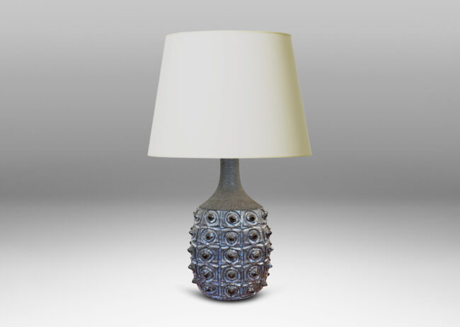 Gallery BAC swelling form with carved design and grid of projecting spines, glazed in pale and dark blue, with sprouting neck in matte brown