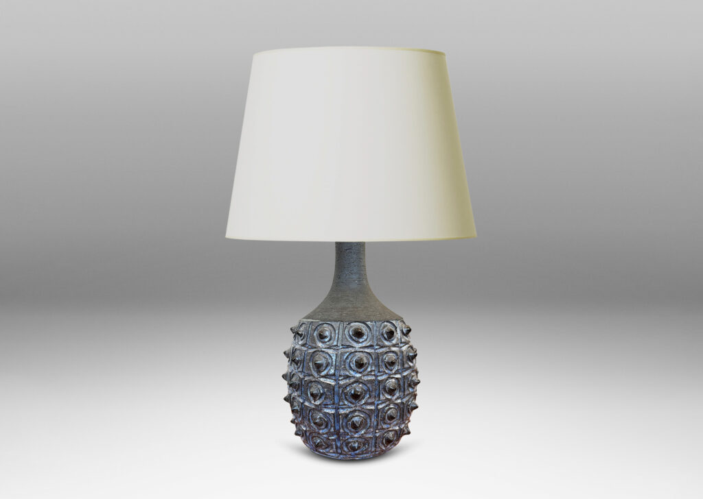 Gallery BAC swelling form with carved design and grid of projecting spines, glazed in pale and dark blue, with sprouting neck in matte brown