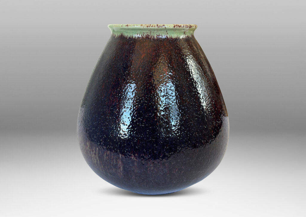 Gallery BAC organically modeled bulbous form with wide mouth, glazed in a shiny oxblood with pale gray accents