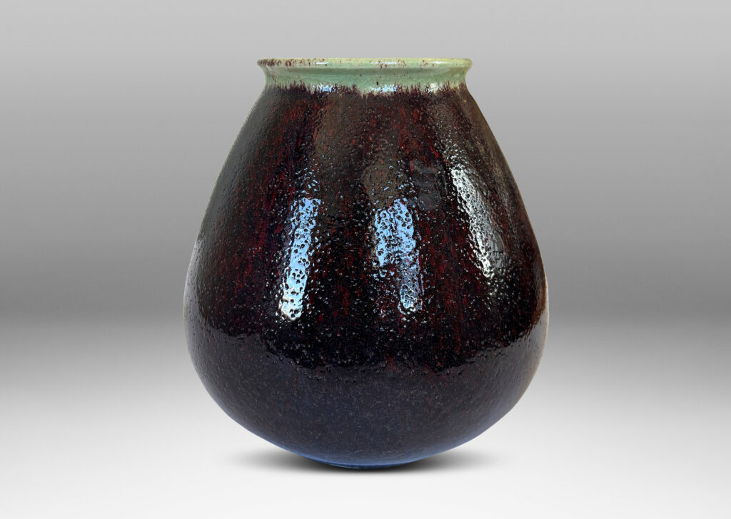 Gallery BAC organically modeled bulbous form with wide mouth, glazed in a shiny oxblood with pale gray accents