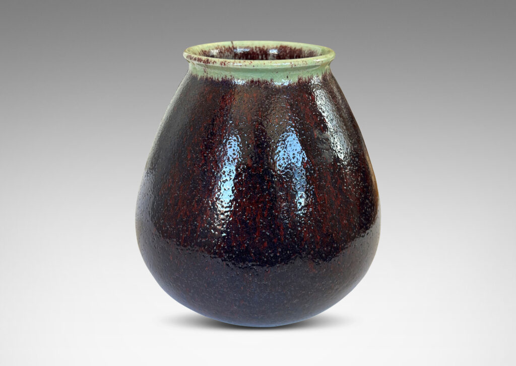 Gallery BAC organically modeled bulbous form with wide mouth, glazed in a shiny oxblood with pale gray accents