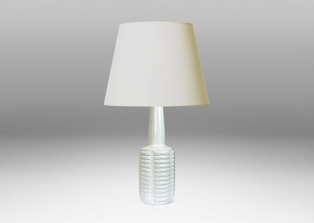 Gallery BAC cylindrical form with stacks of impressed motifs in relief and a tapered neck, glazed in a gloss white