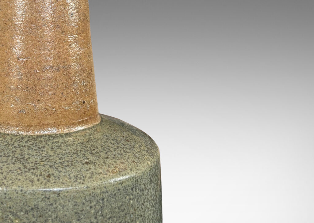 Gallery BAC low drum form with tall conical neck, glazed in brown and blue-gray