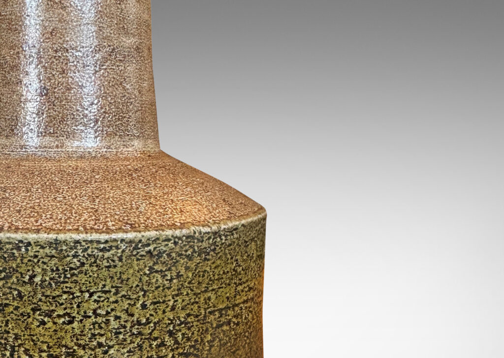 Gallery BAC low rum form with tall conical neck, glazed in brown and a greenish raw umber