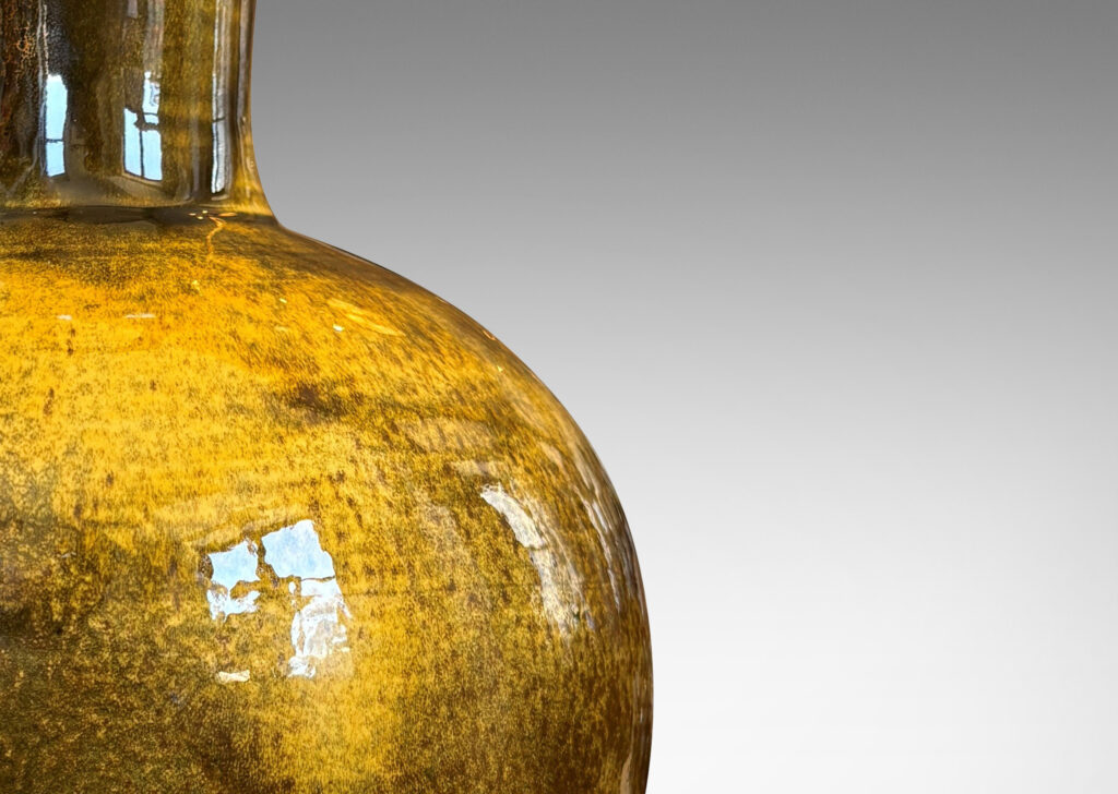 Gallery BAC rationalized baluster form, with spherical body, disk base and flared neck, glazed in yellow-black