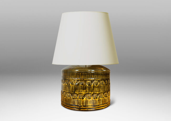 Gallery BAC drum form surrounded in bands of carved strikes and spirals, glazed in yellow-black