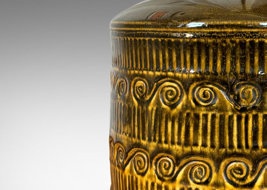 Gallery BAC drum form surrounded in bands of carved strikes and spirals, glazed in yellow-black