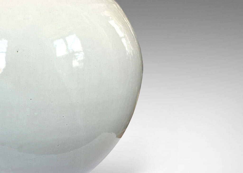 Gallery BAC plump spherical form with unarticulated mouth, glazed in a gloss white