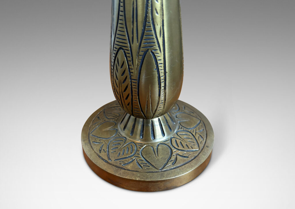 Gallery BAC elongated drop form on a disk plinth, ornamented with carved foliate pattern; patinated brass