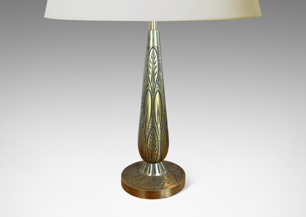 Gallery BAC elongated drop form on a disk plinth, ornamented with carved foliate pattern; patinated brass