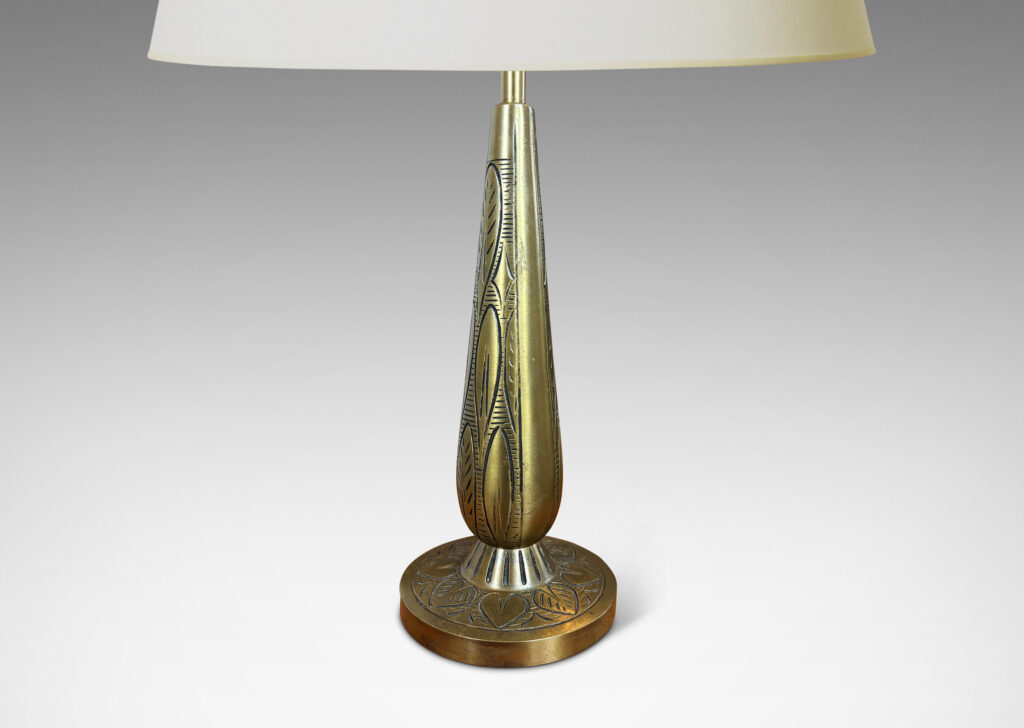 Gallery BAC elongated drop form on a disk plinth, ornamented with carved foliate pattern; patinated brass