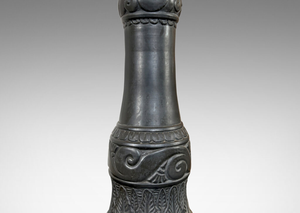 Gallery BAC baluster form ornamented with carved bands of scrolls, leaves, and gadroons, glazed in a matte black