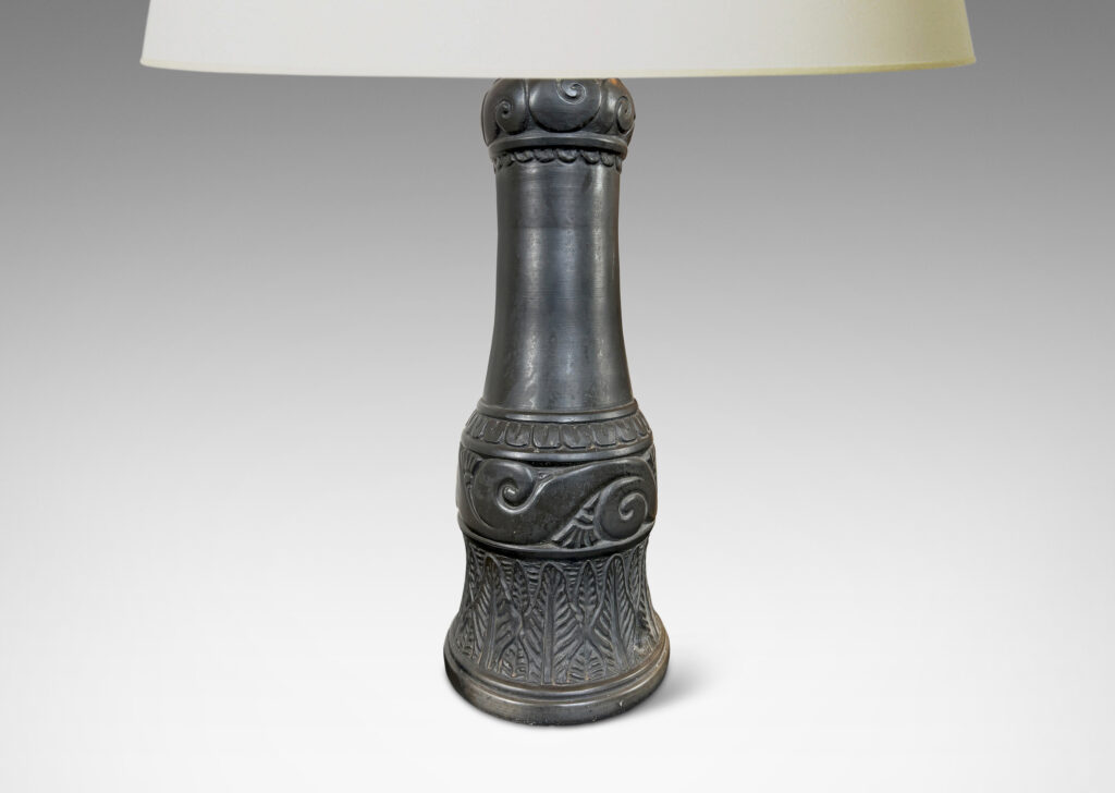 Gallery BAC baluster form ornamented with carved bands of scrolls, leaves, and gadroons, glazed in a matte black
