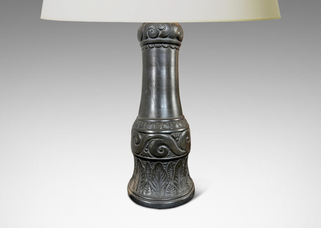 Gallery BAC baluster form ornamented with carved bands of scrolls, leaves, and gadroons, glazed in a matte black