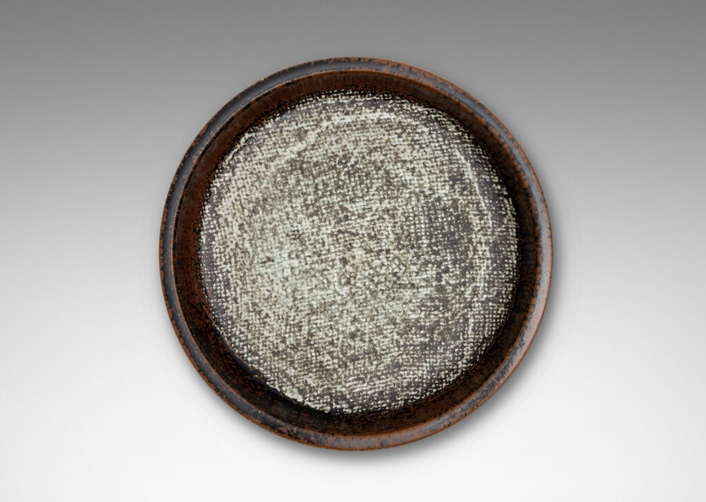 Gallery BAC drum-form with stepped straight sides and a flat bottom with textile-like pattern, glazed in black-red luster on the sides and green-gray-pale gray on the bottom