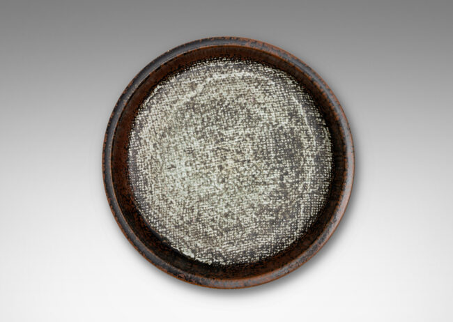 Gallery BAC drum-form with stepped straight sides and a flat bottom with textile-like pattern, glazed in black-red luster on the sides and green-gray-pale gray on the bottom