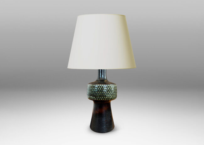 Gallery BAC drum-form fob encircled in impressed triangle motifs floating on a conical base and topped with a sprouting neck, glazed in black and pale gray