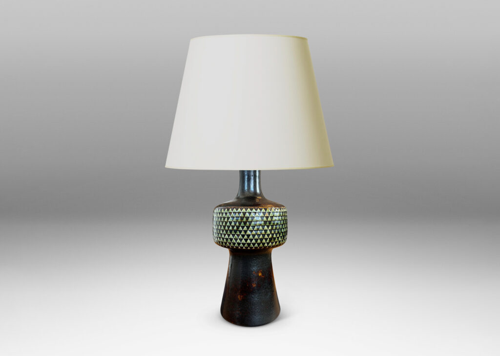 Gallery BAC drum-form fob encircled in impressed triangle motifs floating on a conical base and topped with a sprouting neck, glazed in black and pale gray