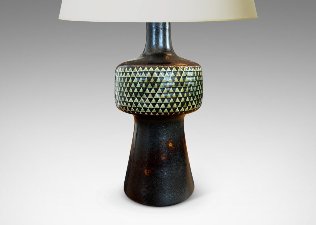 Gallery BAC drum-form fob encircled in impressed triangle motifs floating on a conical base and topped with a sprouting neck, glazed in black and pale gray
