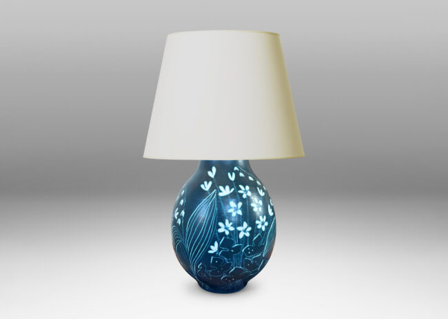 Gallery BAC ovoid form glazed in a deep cerulean tone, with a carved sgraffito wildflower design
